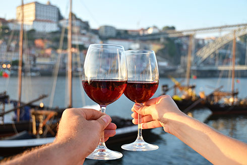 Portwein in Gläsern, vor dem Duoro-Fluss