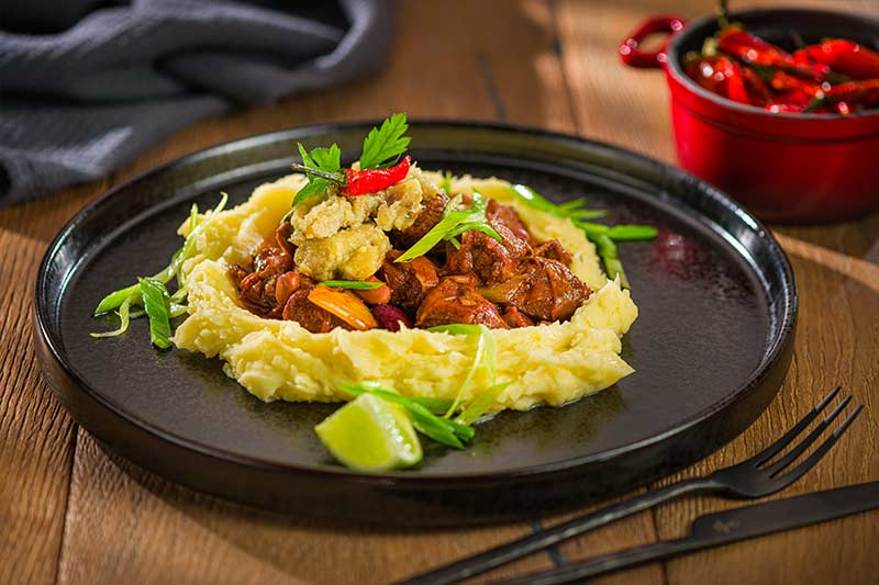 Schweinefleisch in Chipotle-Sud geschmort mit Maniok und Kochbanane